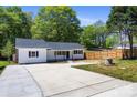 Exterior view of a cozy home with a spacious driveway and well-maintained yard at 3715 Dallas High Shoals Hwy, Dallas, NC 28034