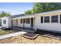 Inviting front porch with wooden beams and a freshly landscaped garden at 3715 Dallas High Shoals Hwy, Dallas, NC 28034