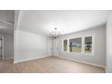 Bright living room with large windows, light wood flooring and a modern chandelier at 3715 Dallas High Shoals Hwy, Dallas, NC 28034