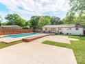Spacious backyard featuring a refreshing in-ground pool, patio area, and lush landscaping at 4303 Greenhaven Ln, Gastonia, NC 28056