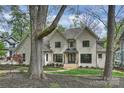 Elegant two-story home showcasing a beautiful brick exterior, manicured lawn and walkway at 438 Wonderwood Dr, Charlotte, NC 28211