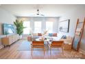 Bright living room with comfortable seating, ceiling fan, and large windows for ample sunlight at 451 Old Town Village Rd, Waxhaw, NC 28173