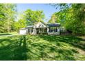 Attractive home boasting great curb appeal with its well-manicured lawn, fresh landscaping, and covered front entrance at 556 Westwood Dr, Kannapolis, NC 28081