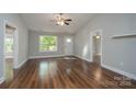 Bright living room with beautiful wood floors, fresh paint, a ceiling fan, and ample natural light at 556 Westwood Dr, Kannapolis, NC 28081