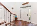 Bright foyer featuring wood floors, a staircase, and a front door with sidelights at 585 Highland Ridge Rd, Mooresville, NC 28115