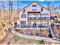 Back exterior view featuring a multi-tiered deck, stairs, balcony and a long winding walkway at 5888 Wood Duck Way, Catawba, NC 28609
