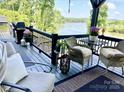 Outdoor seating area with comfortable chairs, a table, grill, plants and a beautiful water view at 5888 Wood Duck Way, Catawba, NC 28609
