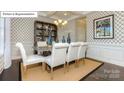 Cozy dining room with decorative wallpaper, tray ceilings, and stylish decor at 7027 Butternut Oak Ter, Huntersville, NC 28078
