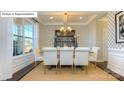 Elegant dining room featuring tray ceilings, decorative wallpaper, and sunlit windows at 7027 Butternut Oak Ter, Huntersville, NC 28078