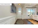 Welcoming entryway with detailed trim, hardwood floors, and stylish decor at 7027 Butternut Oak Ter, Huntersville, NC 28078