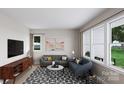 Inviting living room with gray sofa, blue loveseat, modern rug, and ample natural light at 8048 Cedarsmith Ct, Charlotte, NC 28217