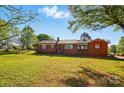Attractive brick home featuring a well-maintained lawn and mature trees at 8408 Mcclure Cir, Charlotte, NC 28216