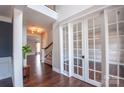 Inviting entryway with hardwood floors, white trim and french doors leading to an office space at 8810 Cool Meadow Dr, Huntersville, NC 28078