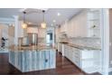 Kitchen with a large island, granite countertops, stainless steel appliances, and white cabinets at 8810 Cool Meadow Dr, Huntersville, NC 28078