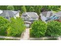 An aerial view of a home with a well-maintained yard and mature trees in a serene neighborhood at 9312 Seamill Rd, Charlotte, NC 28278
