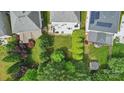 Aerial view of backyard featuring a patio with outdoor seating and lush landscaping at 9312 Seamill Rd, Charlotte, NC 28278
