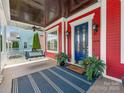 Inviting front porch with a swing, blue door, and plants, creating a cozy entrance at 9636 Cotton Stand Rd, Charlotte, NC 28277
