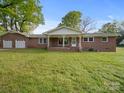 Charming brick home featuring an inviting front porch and attached two-car garage at 101 Stoneybrook Dr, York, SC 29745