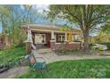 Charming brick home with a covered porch and a lush lawn, perfect for relaxation and curb appeal at 115 E 11Th St, Salisbury, NC 28144