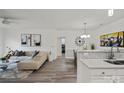 Bright living area showcasing a comfortable sectional sofa, modern decor, and wood floors at 11839 Ridgeway Park Dr, Charlotte, NC 28277
