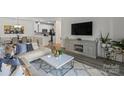 Open-concept living room with modern furniture, stylish decor, and plenty of natural light at 11839 Ridgeway Park Dr, Charlotte, NC 28277
