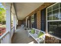 Inviting covered front porch with white columns, comfortable seating, and charming decor at 135 Northbridge Dr, Mooresville, NC 28115