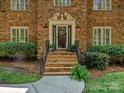 Elegant entryway with brick steps, black railing, and decorative plants at 1413 Willow Oaks Trl, Weddington, NC 28104