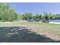 Lakefront property with a lush green lawn leading to a private dock at 143 S Gibbs Rd, Mooresville, NC 28117