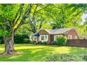 Inviting brick home with manicured lawn and mature trees creating a picturesque setting at 1473 12Th Street Nw Dr, Hickory, NC 28601