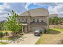 Beautiful two-story brick home with a driveway, two-car garage, and lush landscaping at 17712 Yarwill Ct, Charlotte, NC 28278