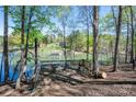Picturesque lake view from a deck, complemented by outdoor seating at 179 Abington Ln, Troutman, NC 28166