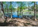 Scenic lake view with a private wooden dock, surrounded by lush trees at 179 Abington Ln, Troutman, NC 28166