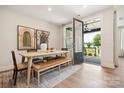 Bright dining area with a modern table, bench seating, and easy access to the outdoor patio at 217 Halemarg Dr, Belmont, NC 28012