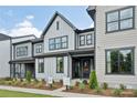 Attractive new construction home boasts a stylish facade with a covered entry and well-manicured landscaping at 217 Halemarg Dr, Belmont, NC 28012