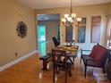Dining room with hardwood floors and a decorative light fixture at 2206 Golden Larch Ln, Waxhaw, NC 28173