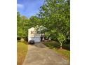Traditional two-story home with an attached garage and manicured lawn at 2206 Golden Larch Ln, Waxhaw, NC 28173