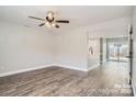 Spacious living room area with hardwood flooring, ceiling fan and adjacent kitchen area at 2335 Brookview Ct, Rock Hill, SC 29732