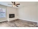 Living room with brick fireplace, hardwood floors, neutral paint and ceiling fan at 2335 Brookview Ct, Rock Hill, SC 29732