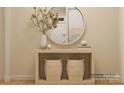 Bright entryway featuring decorative vases, a wooden console table, and round mirror at 2807 Morning Song Way, Lancaster, SC 29720