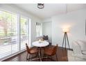 Bright dining nook with white plantation shutters with seating for three at 300 W 5Th St # 136, Charlotte, NC 28202