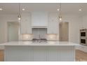 Spacious kitchen featuring an island, stainless appliances, and white cabinets with gold hardware at 3131 Providence Rd # 1A, Charlotte, NC 28211