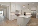Stylish kitchen with a large island, stainless steel appliances, and hardwood flooring at 3131 Providence Rd # 1B, Charlotte, NC 28211