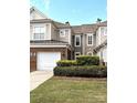 Charming townhome with a one-car garage and brick accents, surrounded by lush landscaping at 44429 Oriole Dr # 102, Indian Land, SC 29707