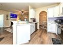 Open kitchen with white cabinets connecting to the dining and living spaces at 44429 Oriole Dr # 102, Indian Land, SC 29707