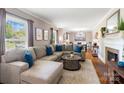 A spacious living room featuring a comfortable sectional sofa and a cozy fireplace at 4626 Fairbluff Pl, Charlotte, NC 28209