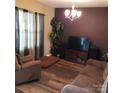 A cozy living room with wood-look floors, comfortable furnishings, and natural light at 464 Laurel Fork Dr, Fort Mill, SC 29715