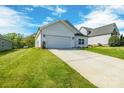 Angle view of house with a well-kept lawn, and attached two-car garage with a concrete driveway at 540 Church St, Locust, NC 28097