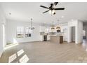 Open-concept living space with bright, natural light, modern fixtures, and hard wood flooring at 540 Church St, Locust, NC 28097