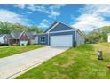 Attractive single-story home with a two-car garage and long driveway at 544 Church St, Locust, NC 28097