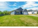 Side view of a charming single-story home with a well-manicured lawn at 544 Church St, Locust, NC 28097